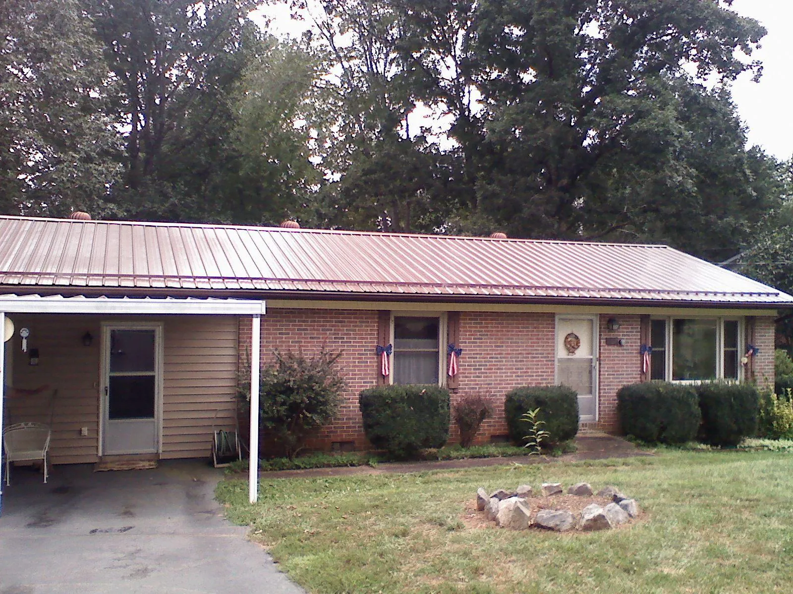 Bronze metal roof and carport on a brick ranch home — Roof Repair work by our crew in Enumclaw